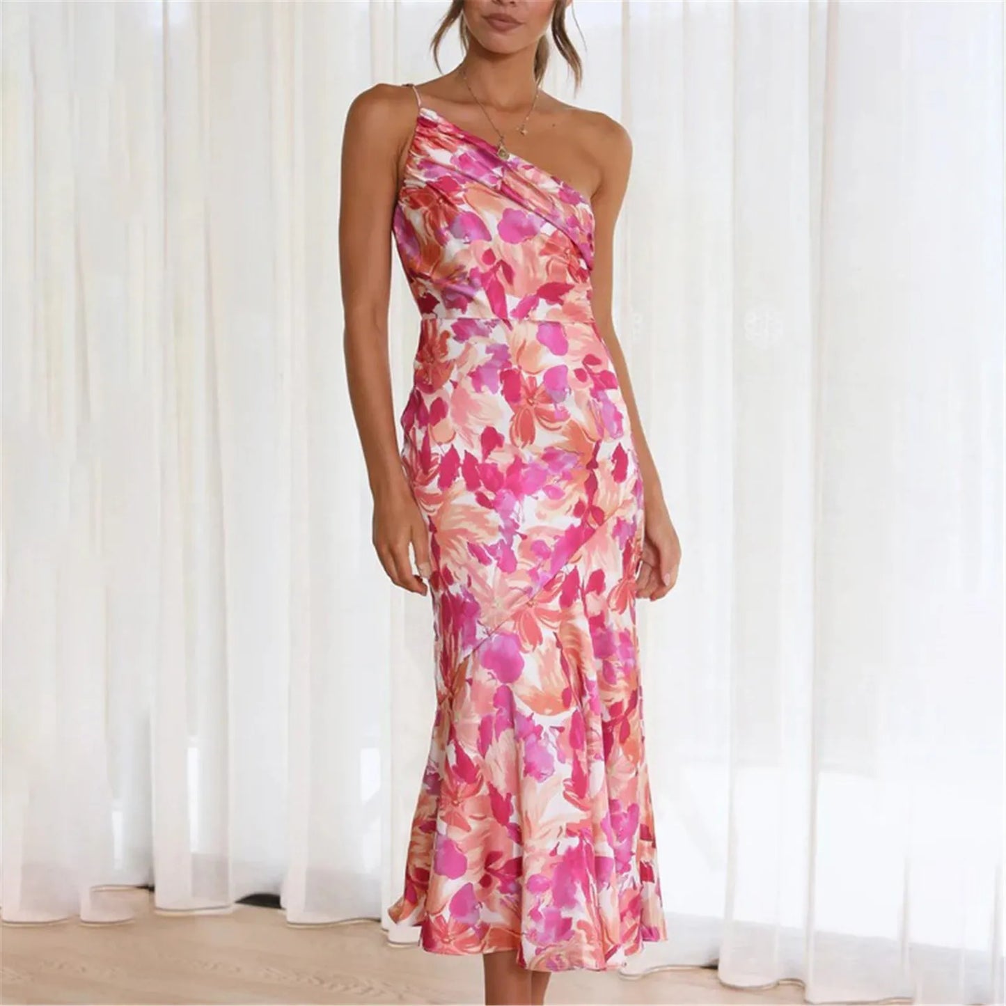 Woman wearing a pink floral one-shoulder midi dress