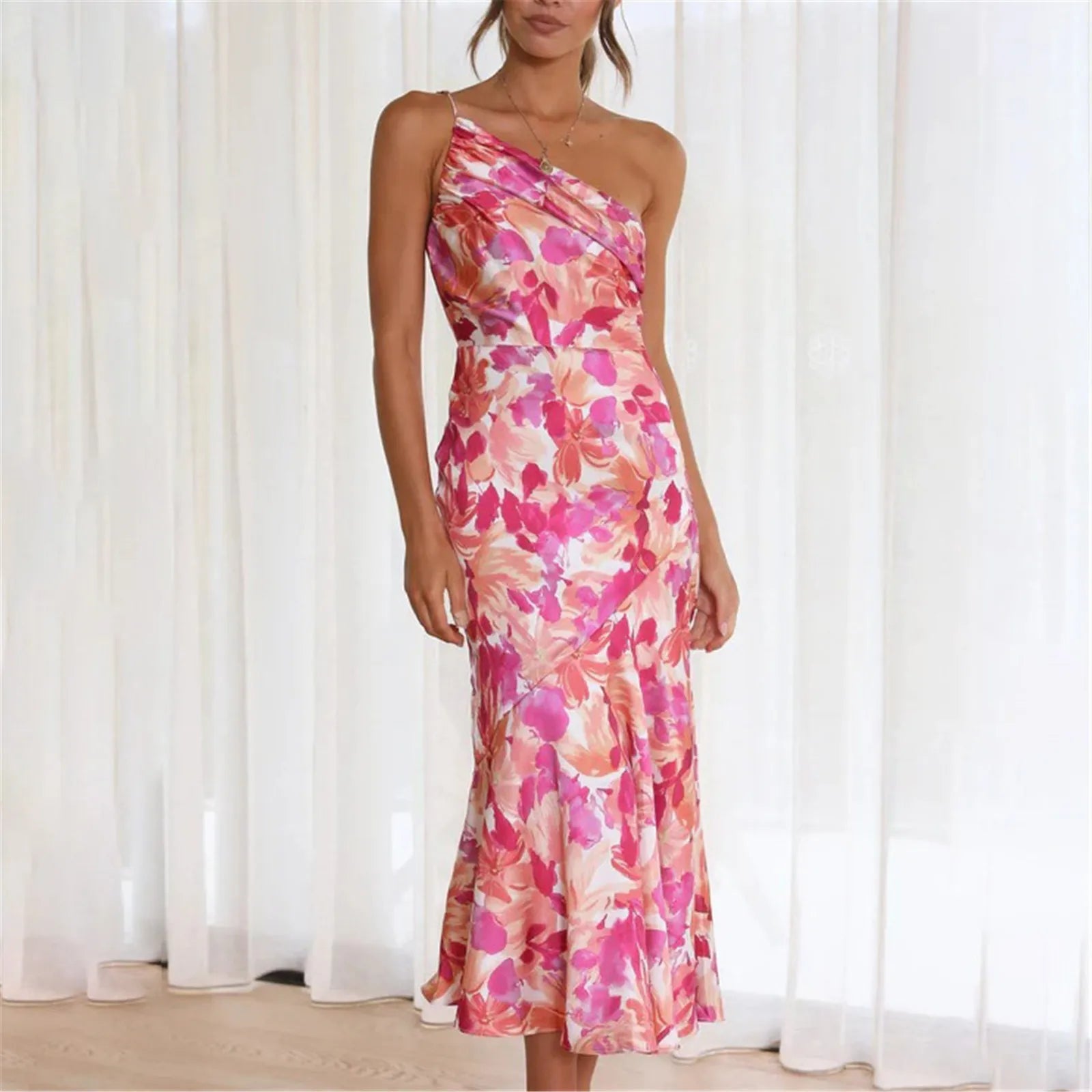 Woman wearing a pink floral one-shoulder midi dress
