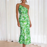 Woman wearing a green floral one-shoulder midi dress