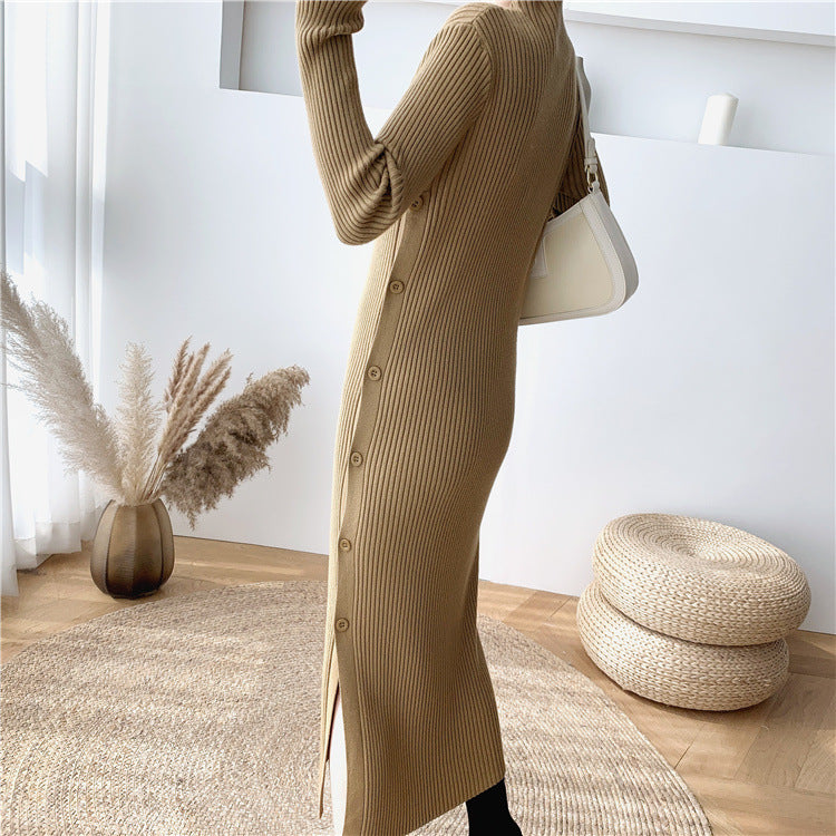 Close-up side view of a woman wearing a long-sleeved, brown ribbed knit dress with a side slit and button details.