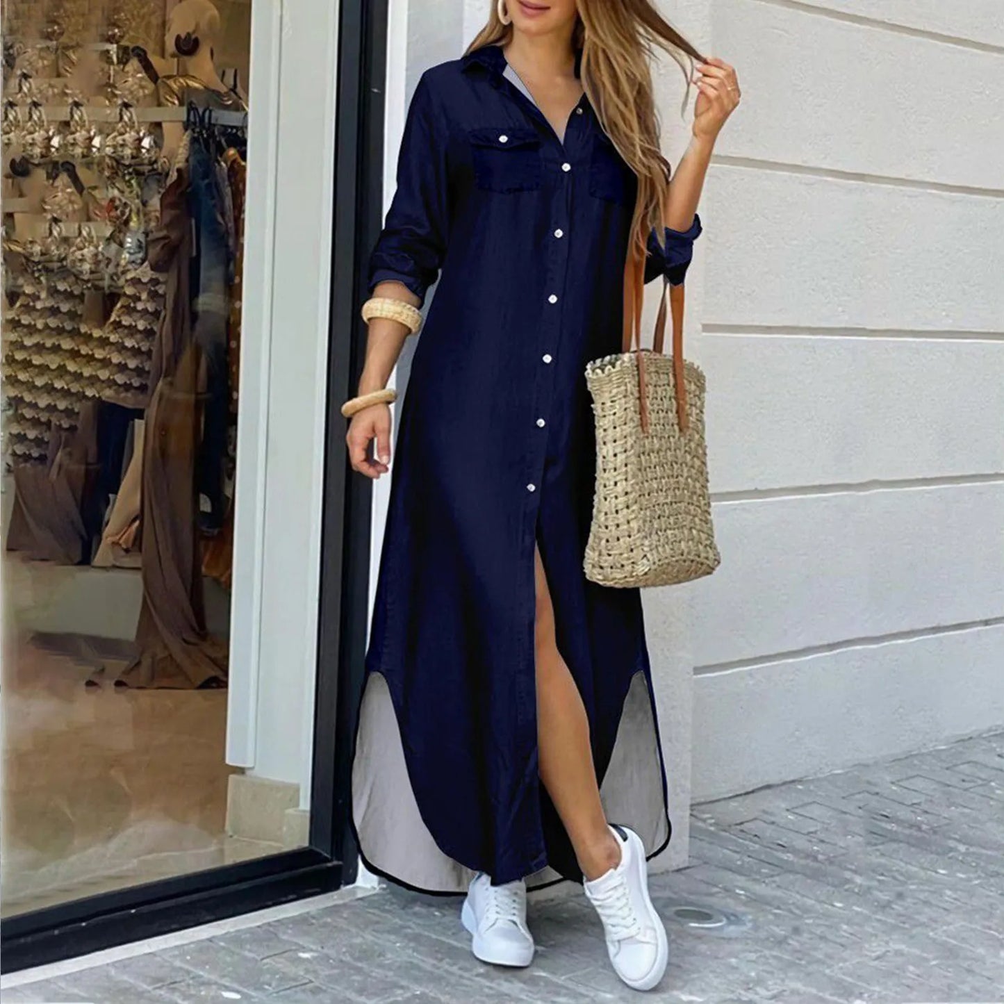 woman in a dark blue maxi shirt dress with a high slit