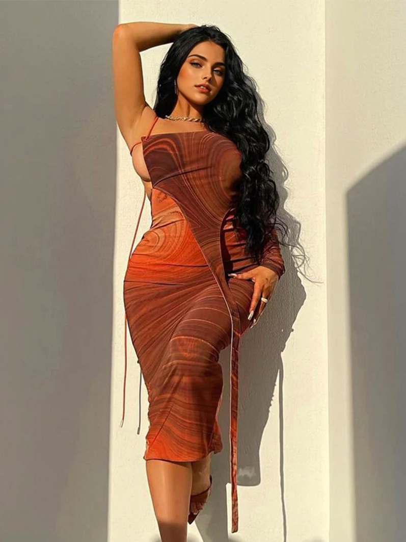 A woman posing in a brown and orange abstract print one-shoulder midi dress with a side cut-out.