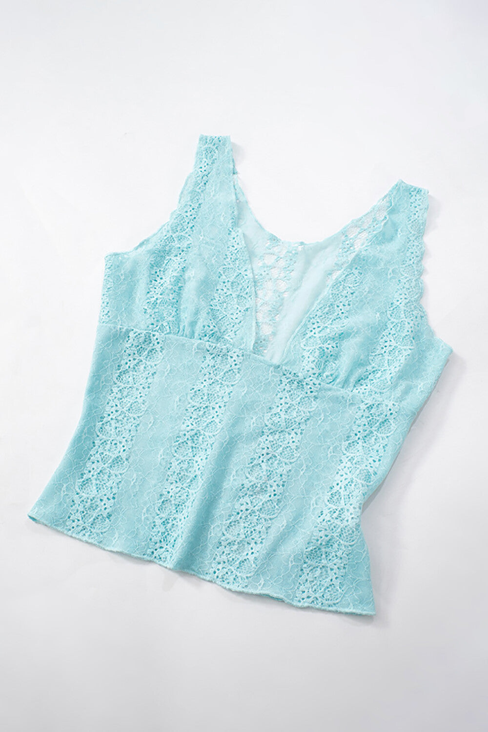 A light blue lace tank top laid flat on a white background
