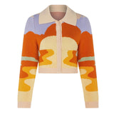 A cropped, collared cardigan with an abstract wave pattern in orange, yellow, cream, light blue, and light green. The cardigan has a button-up front and ribbed cuffs and hem.