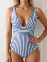 woman in a blue and white striped one-piece swimsuit with a plunging neckline and elasticated waistband