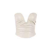 A cream strapless leather corset top with a plunging neckline and draped detailing, isolated on a white background.