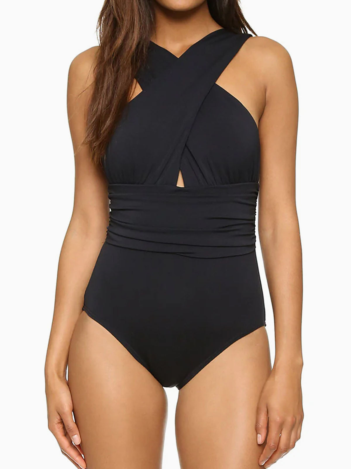 Woman wearing a black one-piece swimsuit with a cross-over halter neckline and ruched waist