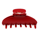 A red claw clip on a white background.
