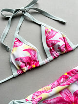 Close-up of a floral print bikini top with mint green trim