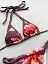 Close-up of a floral print bikini top with brown trim