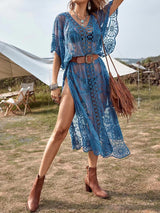 Woman in a blue lace dress with a belt and a fringe bag