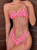 Woman in a pink floral bikini with ruched top and tie details