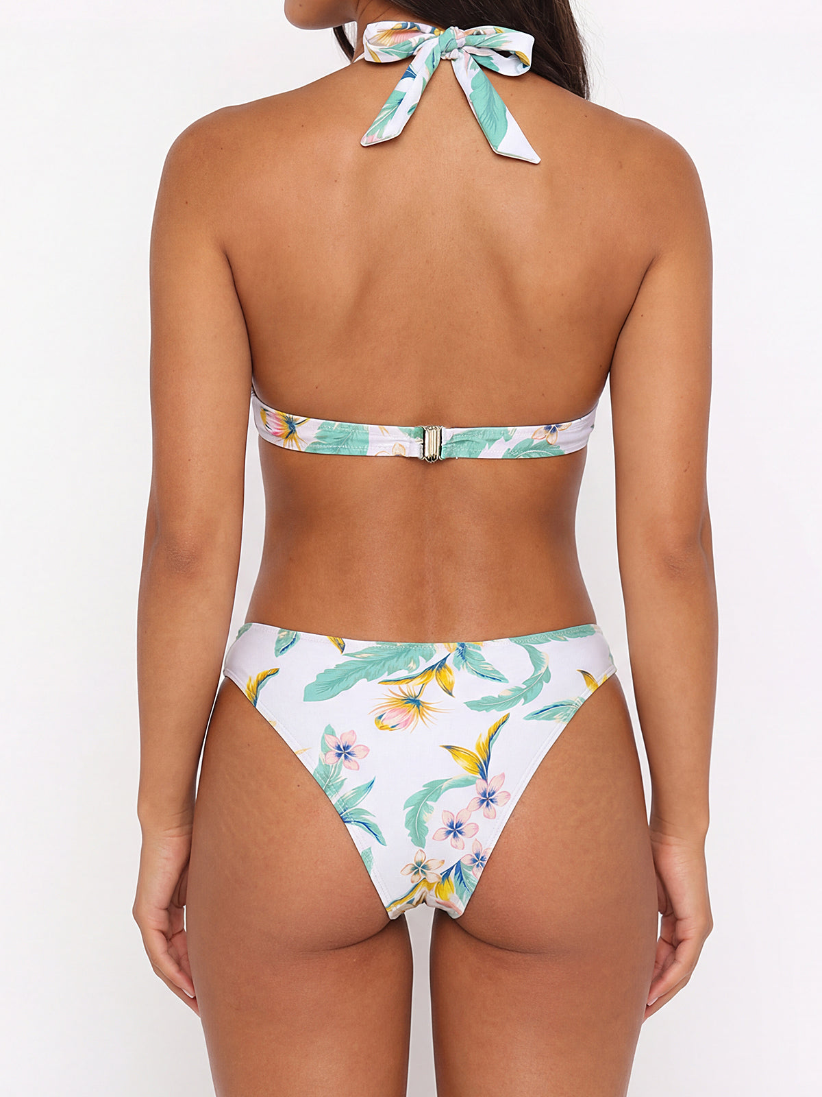 Woman wearing a white floral print bikini, back view
