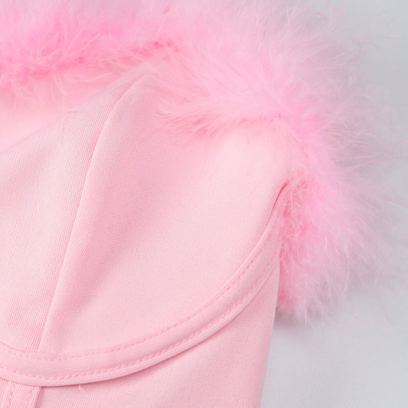 Close-up of a pink strapless corset top with fluffy pink feather trim.