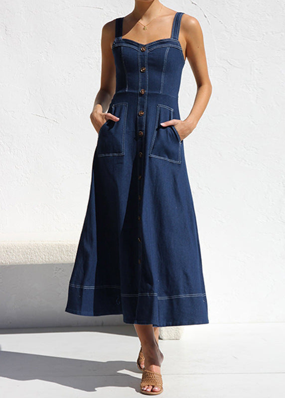 Woman wearing a dark blue denim midi dress with a sweetheart neckline, adjustable straps, and button-down front, featuring large patch pockets with contrast stitching.