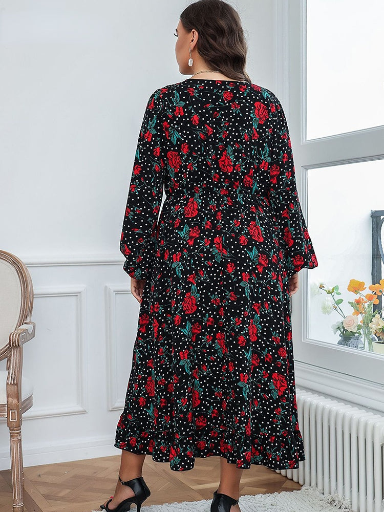Back view of a plus-size woman in a black floral and polka dot midi dress.