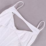 Close-up of the cutout detail and spaghetti straps on a white corset top.
