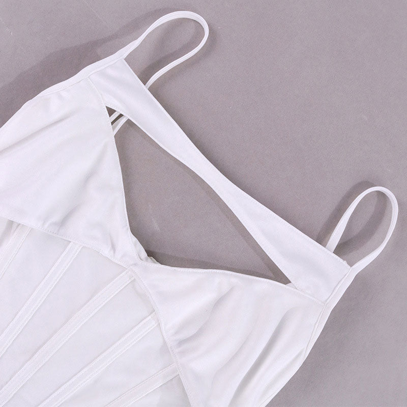 Close-up of the cutout detail and spaghetti straps on a white corset top.