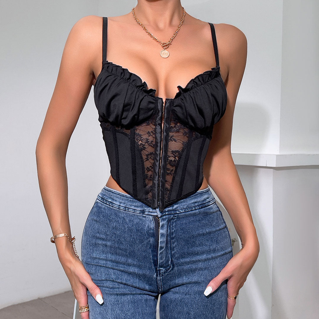 front view of a black lace and ruched corset top with a zipper closure and adjustable straps, worn with blue jeans