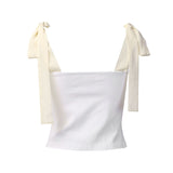 A white ruched bustier top with tie shoulder straps is shown against a white background.
