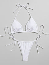 White bikini top and bottom laid flat