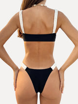 Woman wearing a black and white bikini from the back