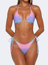 woman wearing a pink, purple, and blue gradient bikini with rhinestone embellishments and tie-side bottoms