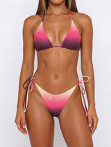 woman wearing a pink and purple gradient bikini with rhinestone embellishments and tie-side bottoms