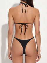 Back view of a woman wearing a black triangle bikini with gold-tone hardware and adjustable ties.