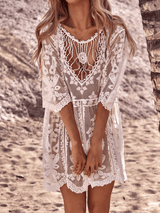 Close-up of a woman in a white lace beach cover-up