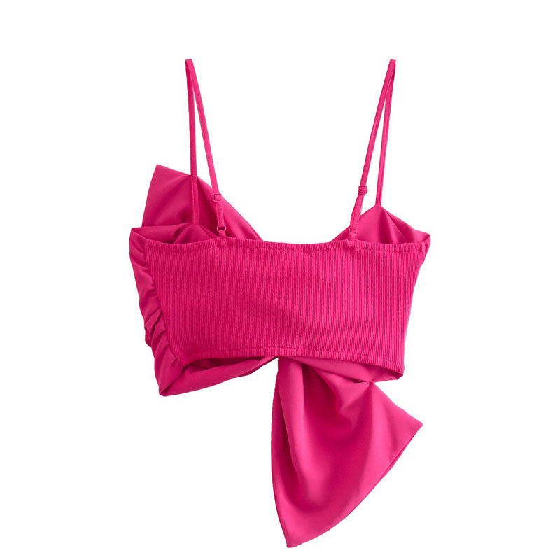 Back of a hot pink bow crop top on a white background