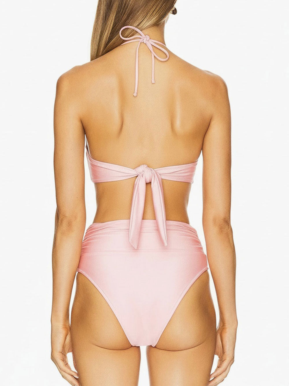 back view of a woman wearing a pink strapless bikini with a halter tie and a pearl embellishment on the bust