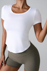 Woman wearing a white cropped top and olive green shorts