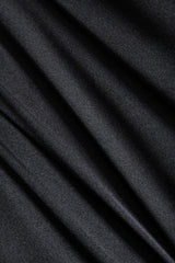 Close-up of the black satin fabric showing its texture and drape.