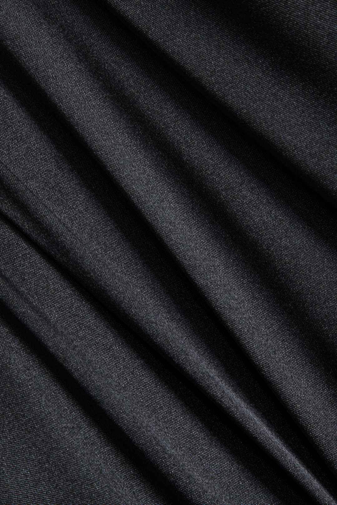Close-up of the black satin fabric showing its texture and drape.