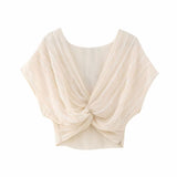 front view of a cream twisted crop top
