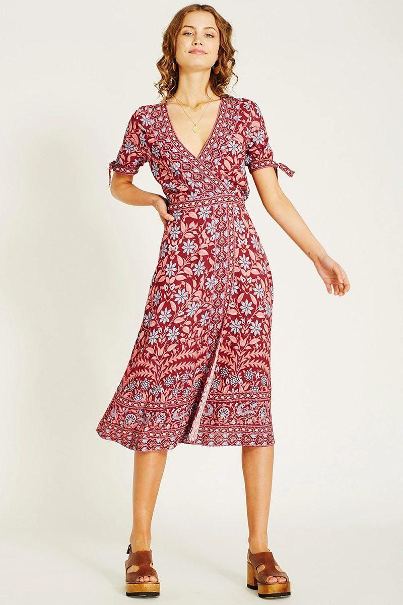 woman in burgundy floral wrap dress and platform sandals