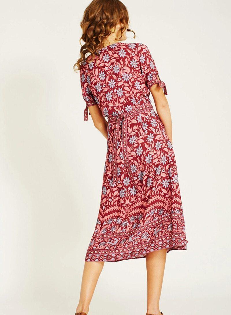 back view of woman in burgundy floral wrap dress