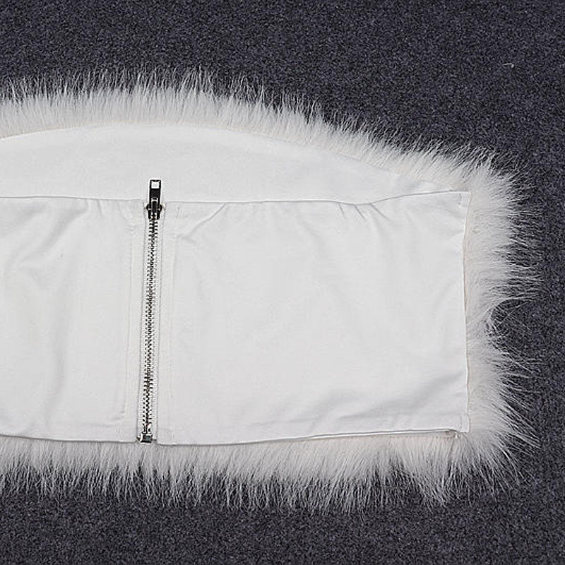 Close-up of the back of a white garment with a zipper closure and a fluffy white fur trim.