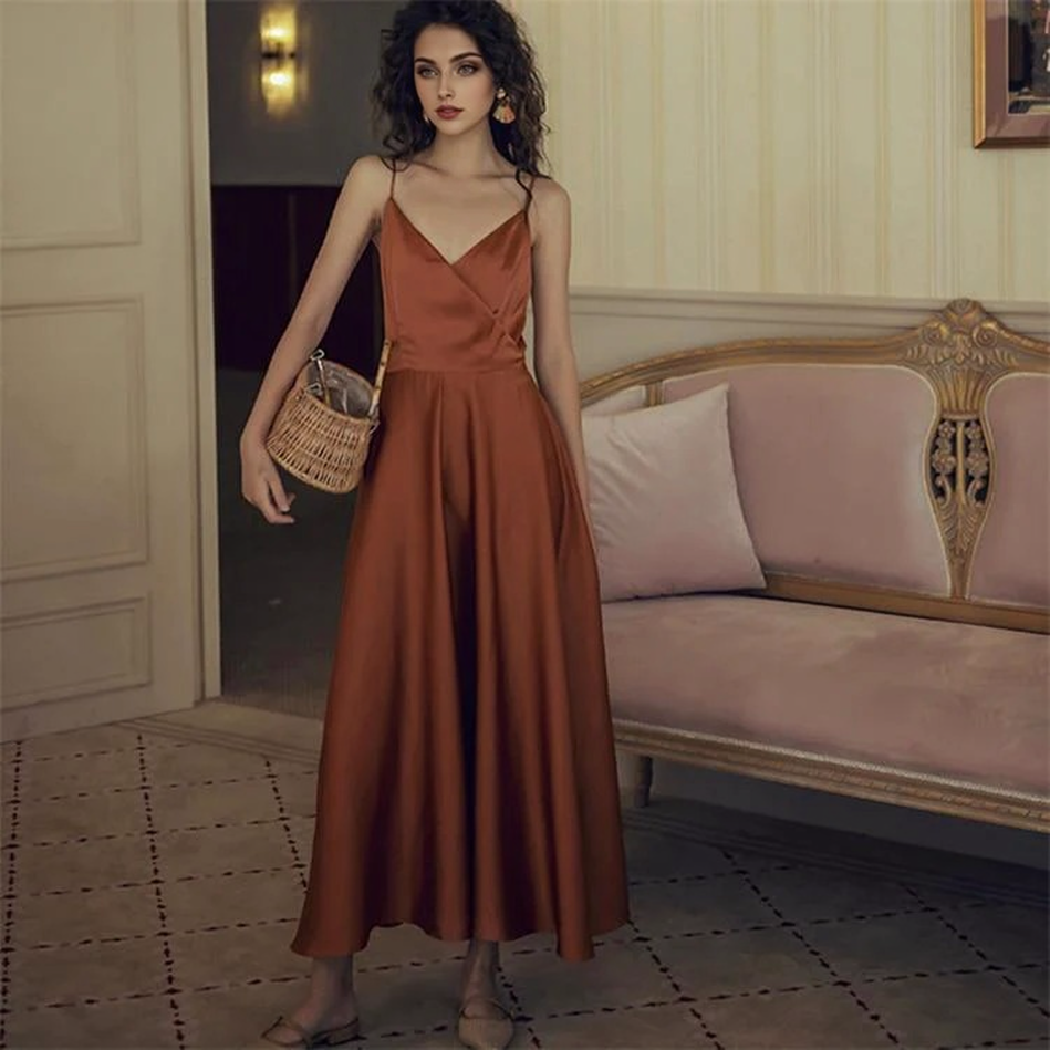 Woman standing and holding a basket, wearing a burnt orange satin dress