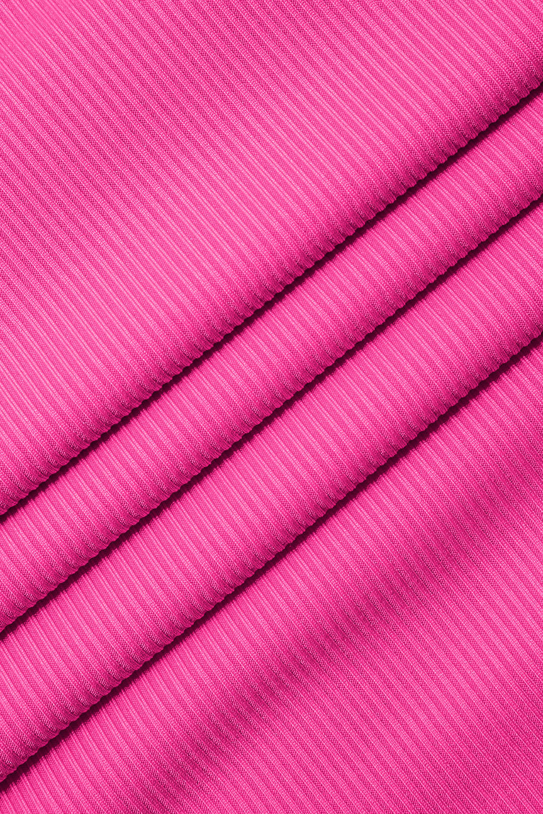 A close-up of bright pink ribbed knit fabric.