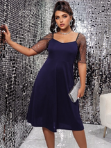 woman in navy blue dress with sequined sleeves