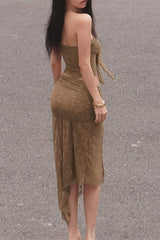 Back view of a woman in a brown sheer outfit.