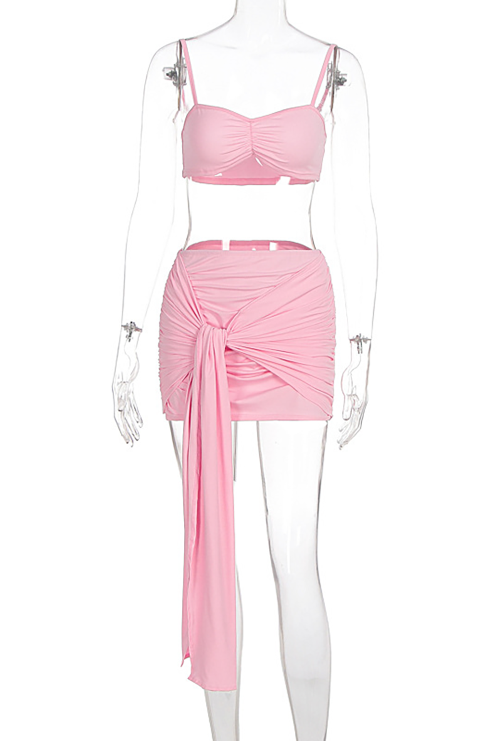 A pink bra top and a pink ruched mini skirt with a tie detail displayed on a mannequin.