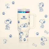 Stanley Snoopy 40 oz insulated tumbler in white with blue Peanuts illustrations, ergonomic handle, and straw - View 1 | Clistos