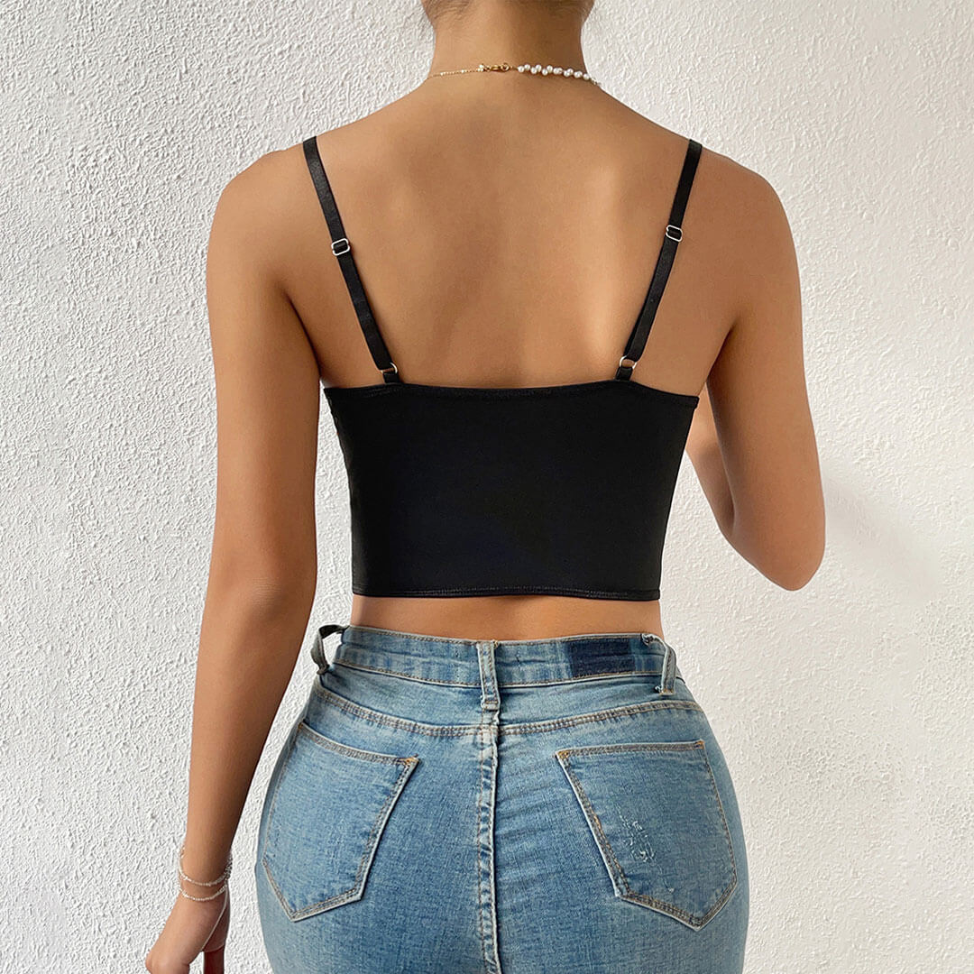 Back view of a woman wearing a black corset top and jeans.