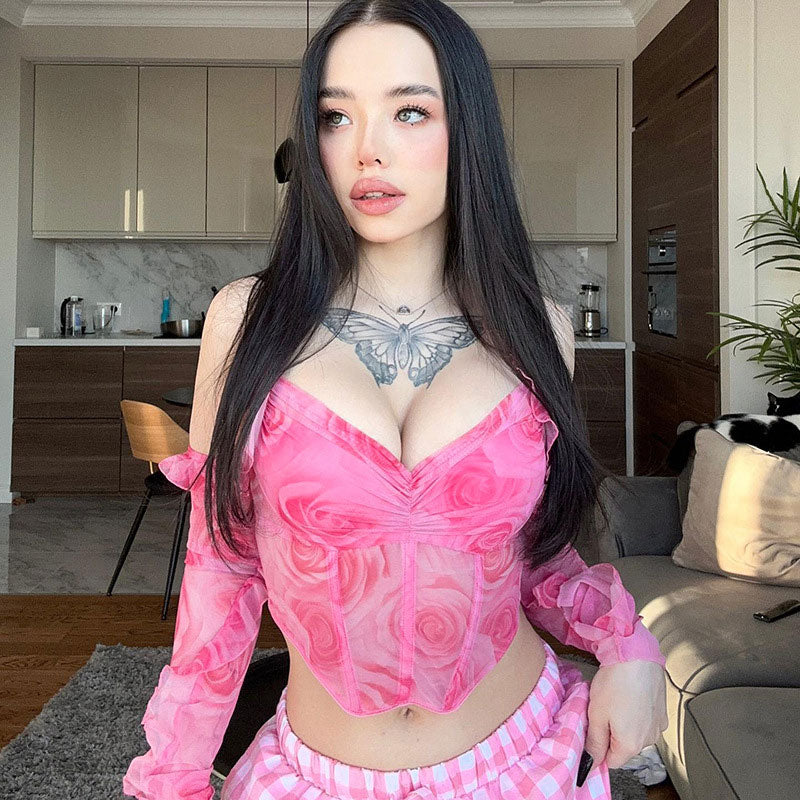 woman in pink rose print sheer off-the-shoulder top and pink plaid pants