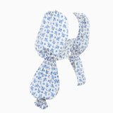 A white and blue floral print cropped top with dramatic puff sleeves and ruffled cuffs, shown flat.