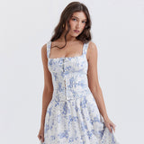 Woman wearing a white and blue floral print corset top with matching skirt