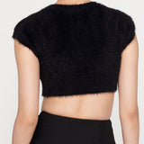 The back of a black fuzzy cropped short-sleeved cardigan.